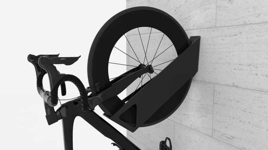 Velohawk Kāhu wall-mounted bike rack holding a road bike on a stone wall